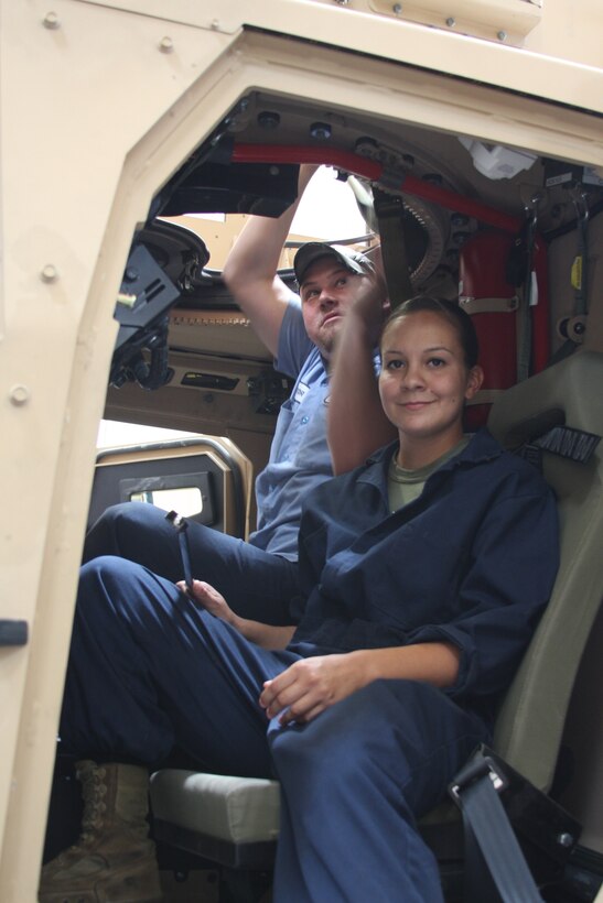 Lance Cpl. Lisa Werth, and Kyle Matthews, motor technician mechanics with the Exercise Support Division, test the turret and functions of an M-ATV, Wednesday in an ESD garage. The vehicle mechanic ratio is 45-1.